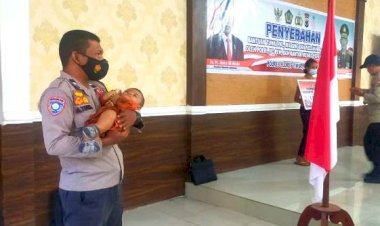 Salut,-Bhabinkamtibmas-Ini-Gendong-Bayi-Sesaat-Ibunya-Terima-Bantuan